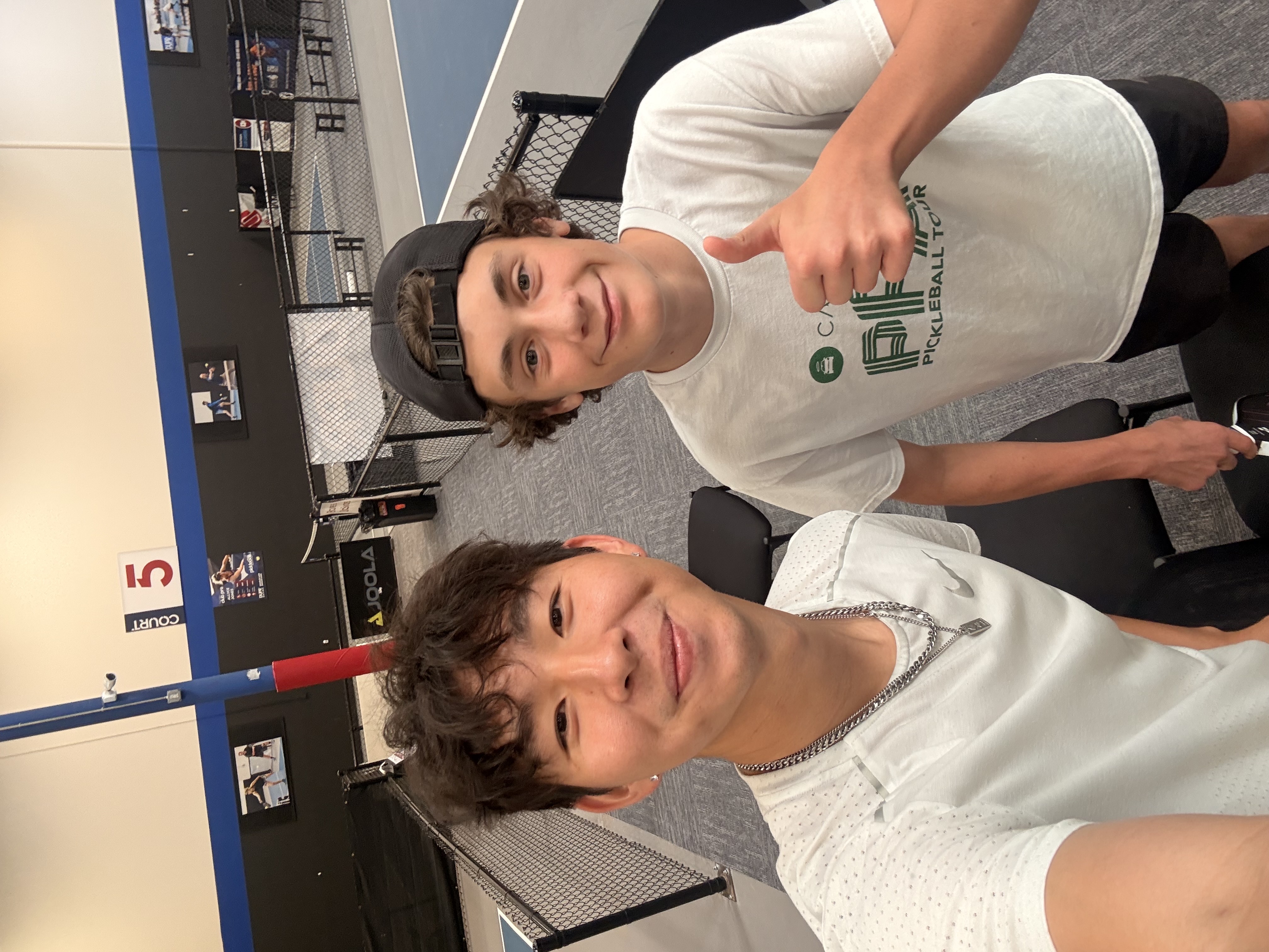 Howard with a friend at an indoor pickleball court
